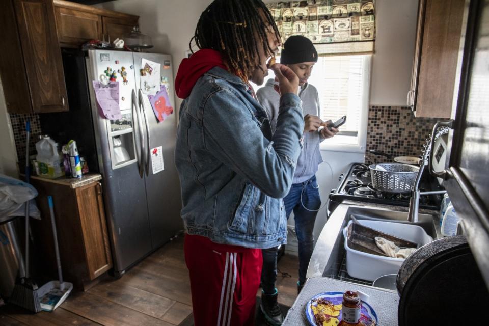 Taevion Rushing eats lunch at home with his cousin, Kyren.