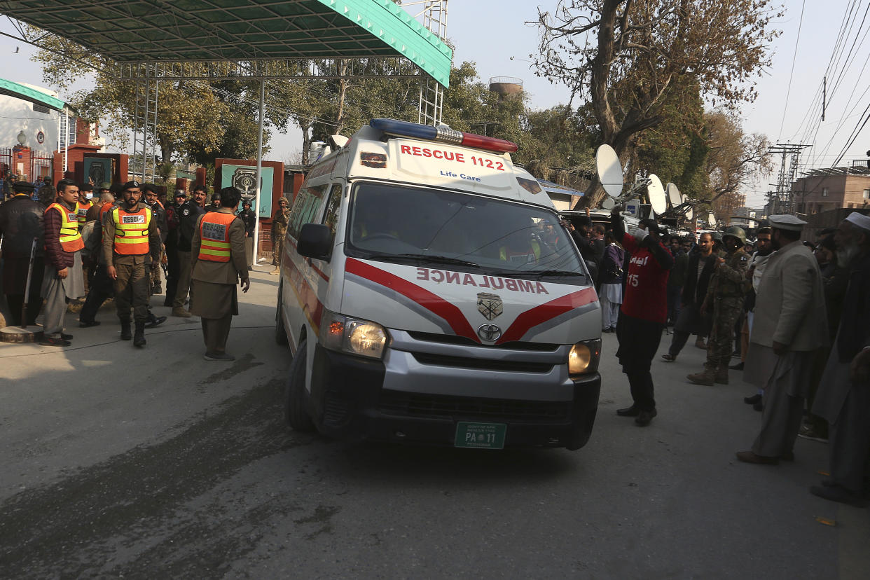 An ambulance carries wounded people toward a hospital from a bomb explosion site in Peshawar, Pakistan, Monday, Jan. 30, 2023. (AP Photo/Muhammad Sajjad)