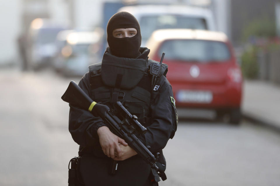 <p>A special police officer secures a street near the house where a Syrian man lived before the explosion in Ansbach, southern Germany, Monday, July 25, 2016. (AP Photo/Matthias Schrader)</p>