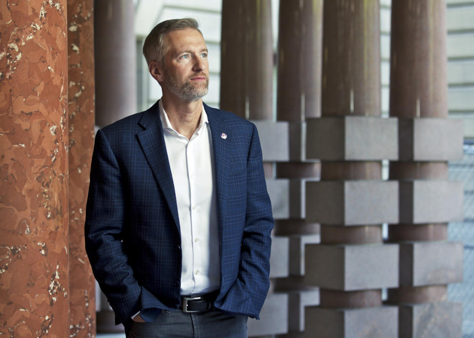 FILE - Portland Mayor Ted Wheeler poses for a photo, Aug. 5, 2019, in Portland, Ore. For years, liberal cities in the U.S have tolerated people living in tents in parks and public spaces, but increasingly leaders in places like Portland, Oregon, New York and Seattle are removing encampments and pushing other strict measures that would've been unheard of a few years ago. In early 2022, Wheeler used emergency powers to ban camping on the sides of certain roadways in the city. (AP Photo/Craig Mitchelldyer, File)