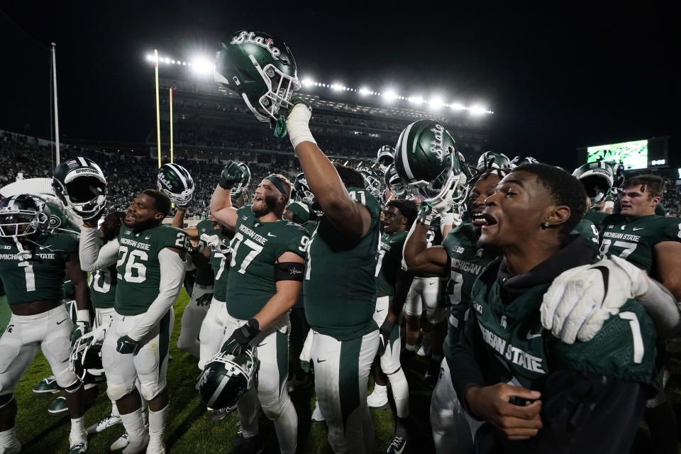 The Michigan State team celebrates after their overtime win in an NCAA college football game against Wisconsin, Saturday, Oct. 15, 2022, in East Lansing, Mich. (AP Photo/Carlos Osorio)