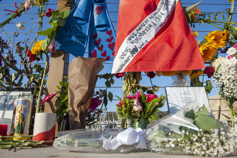 Items are placed at a memorial for the victims of Monday's dive boat fire at the Santa Barbara Harbor on Wednesday, Sept. 4, 2019, in Santa Barbara, Calif. (AP Photo/Christian Monterrosa )