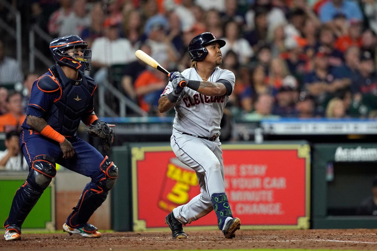 Cleveland Guardians' Jose Ramirez, right, hits a two-run home run as Houston Astros catcher Martin Maldonado watches during the fifth inning of a baseball game Monday, May 23, 2022, in Houston. (AP Photo/David J. Phillip)