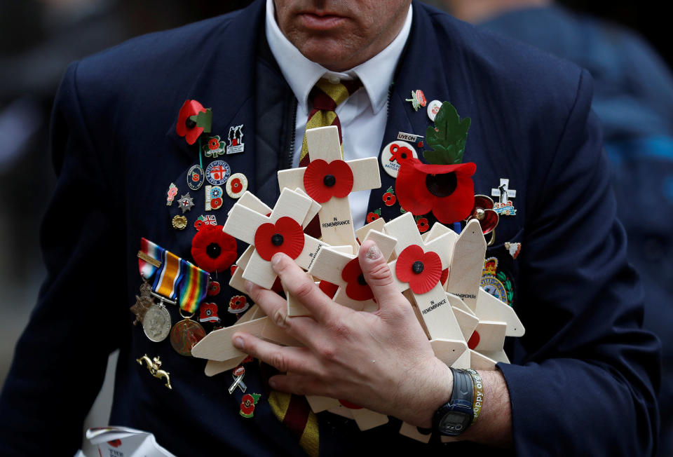 <p>Member of the Royal British Legion carries wooden crosses adorned with poppies at the Field of Remembrance in London, Britain, Nov. 11, 2017. (Photo: Peter Nicholls/Reuters) </p>