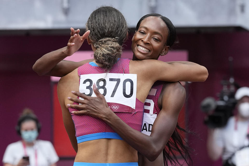 Sydney McLaughlin, left, of the U.S., embraces Dalilah Muhammad, after their semifinal of the women’s 400 meters at the 2020 Summer Olympics on Wednesday. (AP Photo/David J. Phillip) - Credit: AP