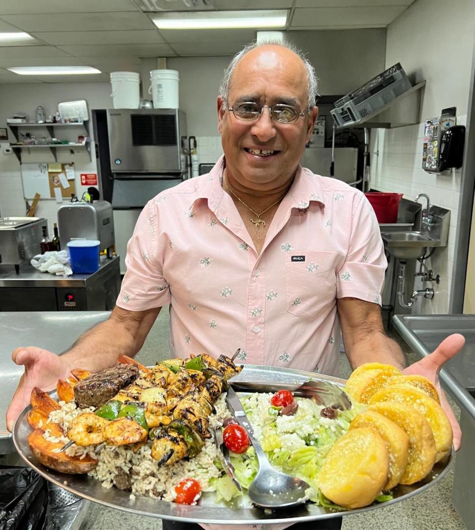 Mark Shaheen, co-owner of the Desert Inn, displays the Arabic platter, the restaurant's top-selling dish. The item was first featured at a downtown Canton bar owned by his late father, John.