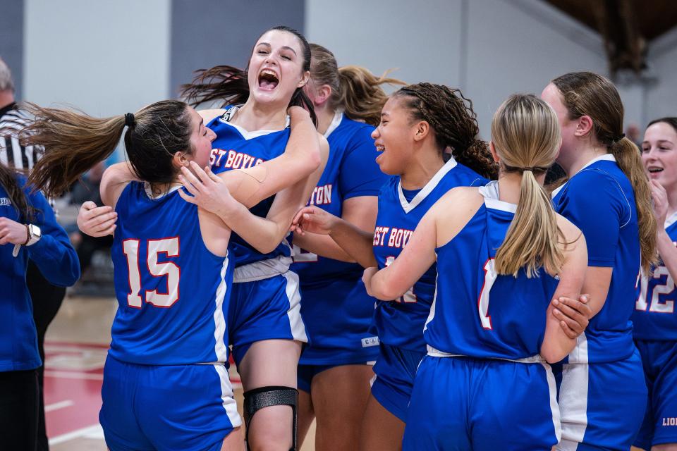 West Boylston players celebrates after the Lions defeated Sutton, 49-47, to claim the Clark Tournament Small Schools title Saturday.