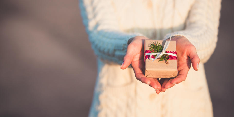 Picture of female hands giving a Christmas present