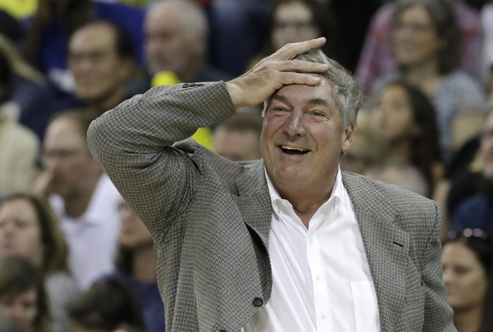 Bill Laimbeer reacts after a foul call by putting his hand to his forehead in an exasperated laugh.