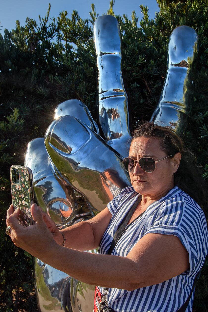 Raquel Morales, 60, of Los Angeles, takes a selfie in front of 800-pound 