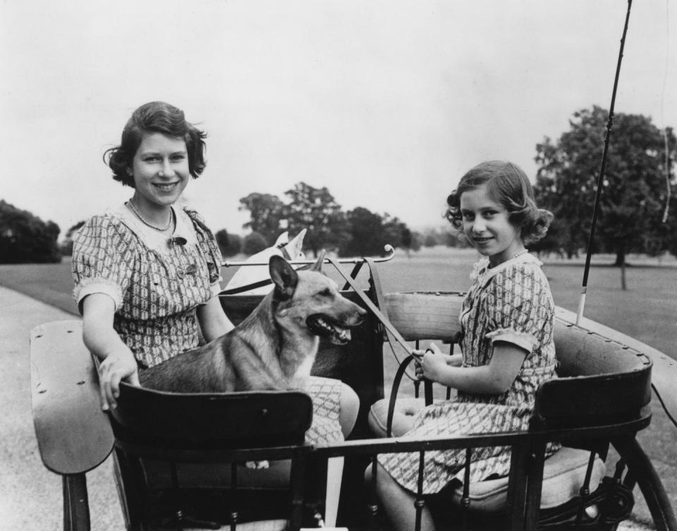 <p>Princess Elizabeth and Princess Margaret spend time with one of the family's royal canines at Windsor. Today, the Queen has a well-known love for corgis and has owned many in her lifetime. </p>