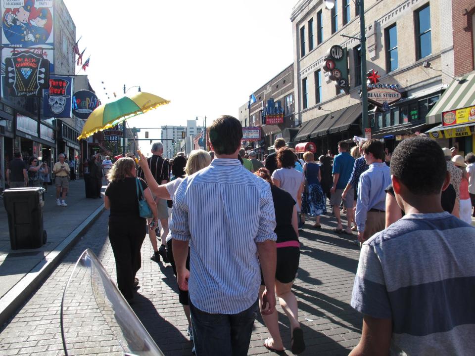 A funeral parade down Memphis' Beale Street honored late soul bassist Donald "Duck" Dunn on Wednesday, May 23, 2012 in Memphis, Tenn. More than 100 fans walked and danced down the Memphis drag during the New Orleans-style parade to remember Dunn, who died May 13 at age 70 while on tour in Japan. (AP Photo/Adrian Sainz)