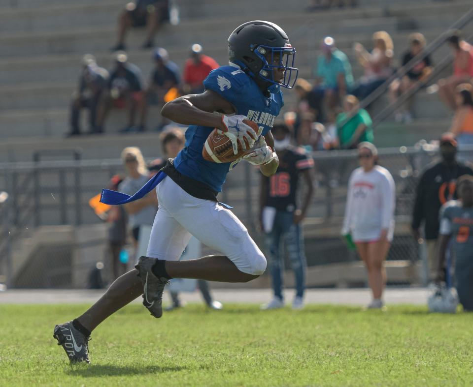 Wildwood’s Vernell Brown III (1) runs with the ball during a 2021 preseason jamboree at Leesburg High School in Leesburg. Brown recently received an offer to play for Michigan.