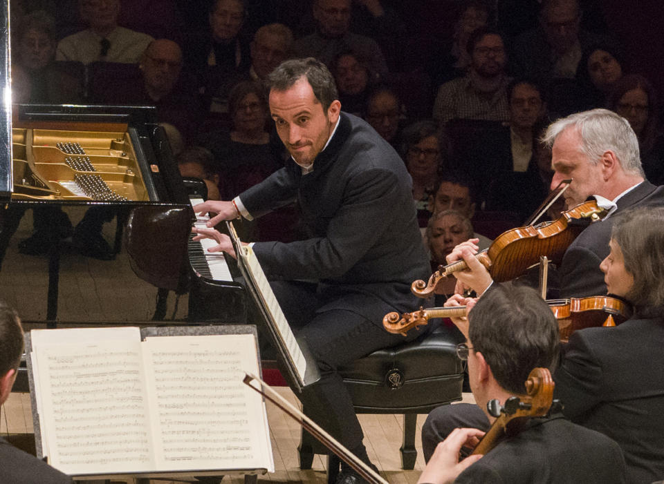 This March 5, 2019 photo released by Carnegie Hall shows pianist Igor Levit performing with the Vienna Philharmonic Orchestra at Carnegie Hall in New York. The 32-year-old pianist, winner of last year’s Gilmore Artist Award, is among the most probing young artists in classical music. (Richard Termine/Carnegie Hall via AP)