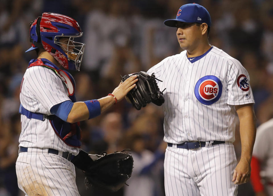 Chicago Cubs' Jorge De La Rosa, right, and Victor Caratini celebrate their win over the Cincinnati Reds at the end of a baseball game Friday, Sept. 14, 2018, in Chicago. (AP Photo/Jim Young)