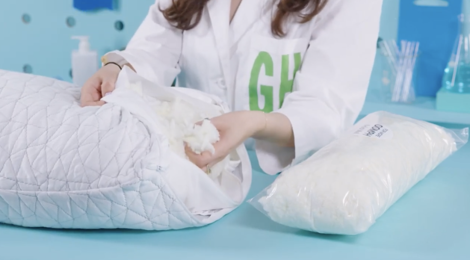 an analyst testing the fill of the coop home goods pillow at good housekeeping