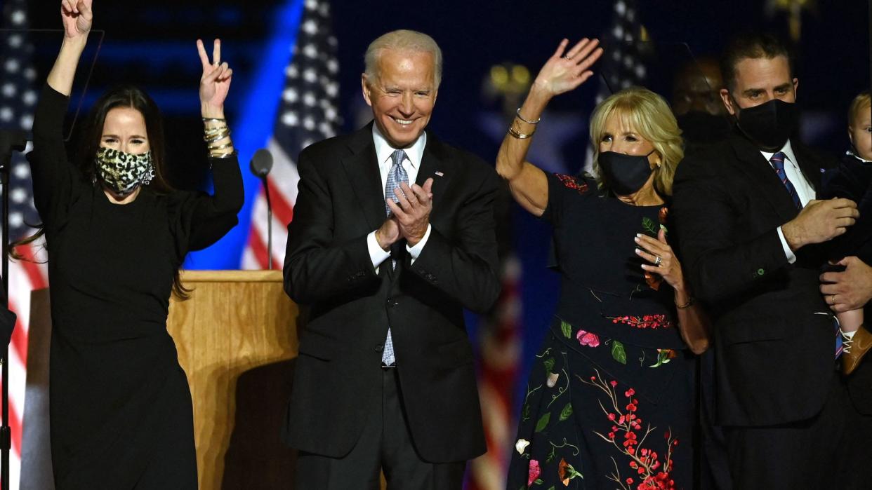 Ashley Biden, daughter of Joe Biden, US President-elect Joe Biden, wife Jill Biden and Hunter Biden salute the crowd after delivering remarks in Wilmington, Delaware, on November 7, 2020