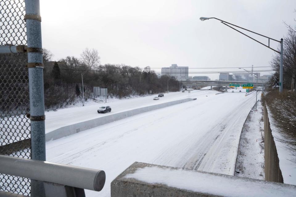 Vehicles slowly drive on I-71 as Columbus endures a winter storm Friday.