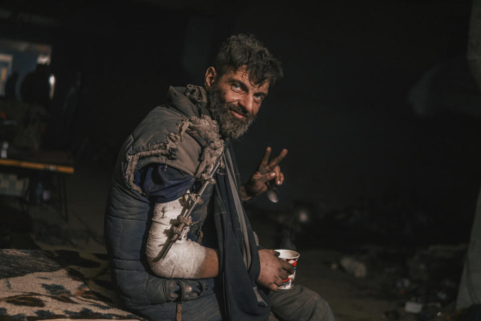 FILE - In this photo provided by Azov Special Forces Regiment of the Ukrainian National Guard Press Office, an Azov Special Forces Regiment's serviceman, injured during fighting against Russian forces, poses for a photographer inside the Azovstal steel plant in Mariupol, Ukraine, Tuesday, May 10, 2022. The Ukrainian forces who made a determined last stand in a Mariupol steel mill against Russian troops were a mixture of seasoned soldiers, border guards, a controversial national guard regiment and volunteers who took up arms in the weeks before Russia's invasion (Dmytro 'Orest' Kozatskyi/Azov Special Forces Regiment of the Ukrainian National Guard Press Office via AP)