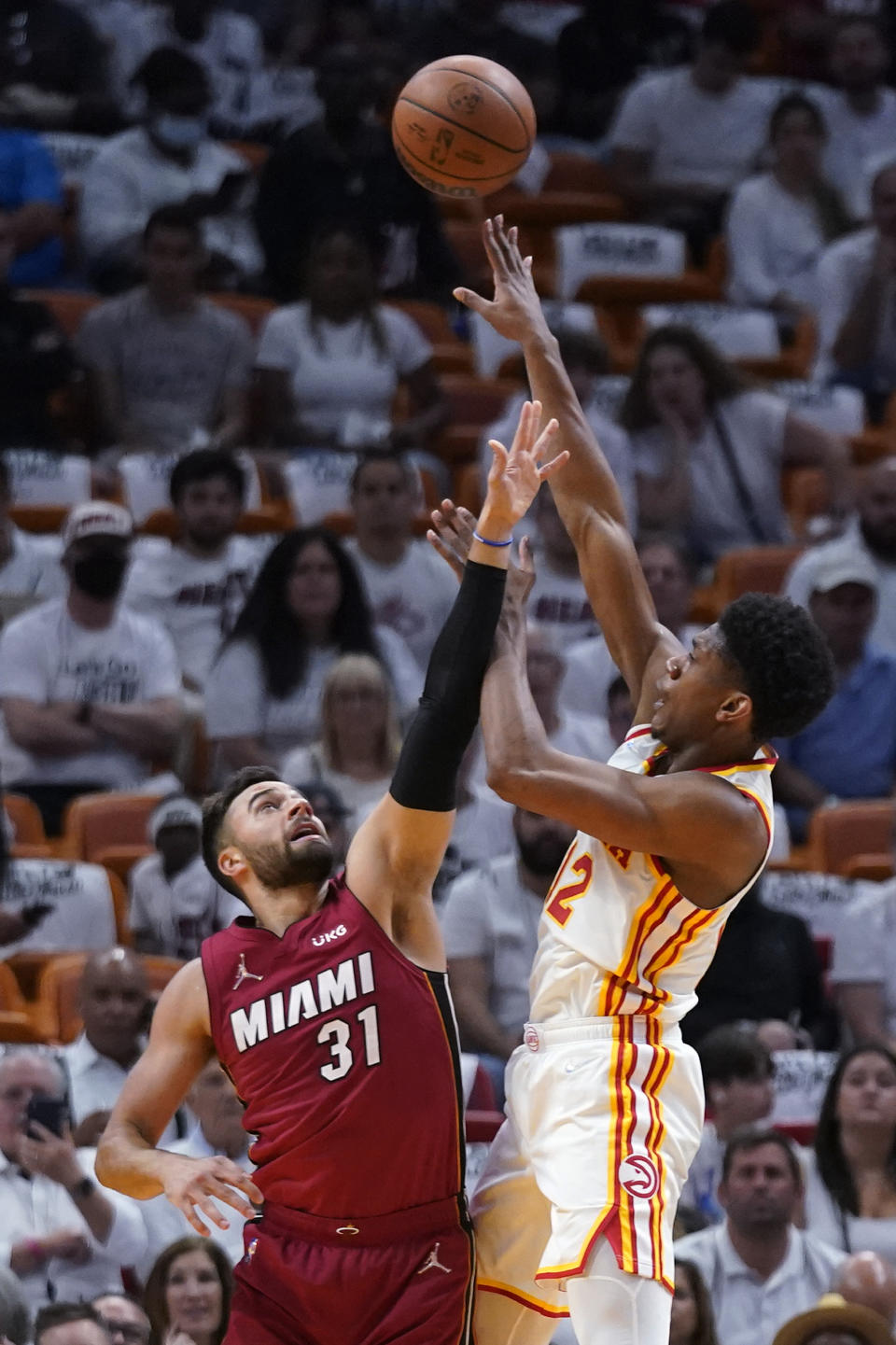 Atlanta Hawks forward De'Andre Hunter, right, takes a shot against Miami Heat guard Max Strus (31) during the first half of Game 5 of an NBA basketball first-round playoff series, Tuesday, April 26, 2022, in Miami. (AP Photo/Wilfredo Lee)