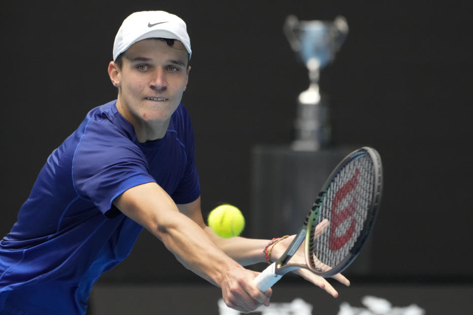 Jakub Mensik of the Czech Republic plays a backhand return to Bruno Kazuhara of the U.S. in the boys' singles final at the Australian Open tennis championships on Saturday, Jan. 29, 2022, in Melbourne, Australia. (AP Photo/Mark Baker)