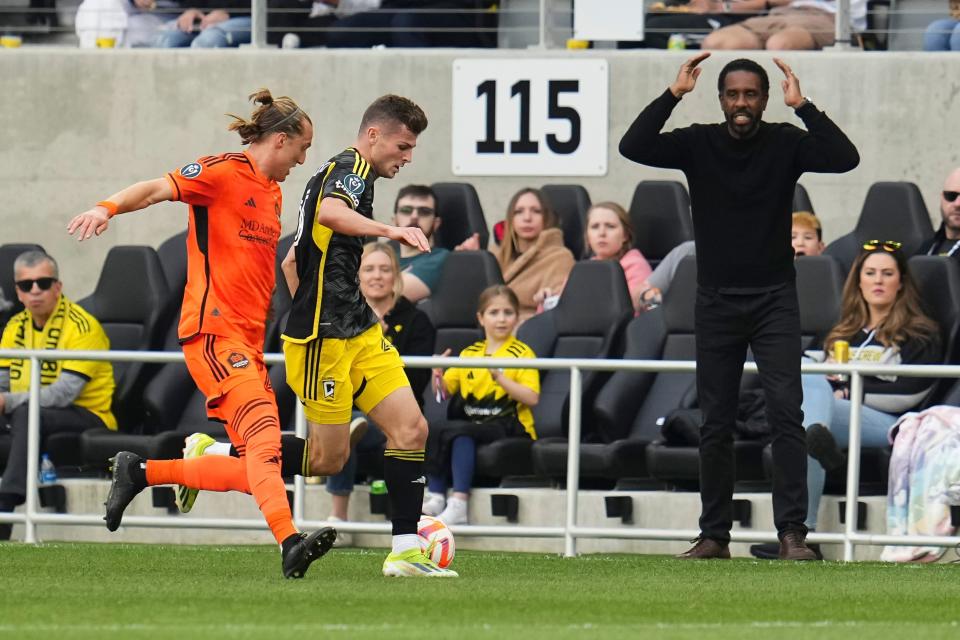 Mar 12, 2024; Columbus, OH, USA; Columbus Crew head coach Wilfried Nancy reacts as midfielder Sean Zawadzki (25) dribbles past Houston Dynamo midfielder Griffin Dorsey (25) during the first half of the Concacaf Champions Cup soccer game at Lower.com Field. Mandatory Credit: Adam Cairns-USA TODAY Sports