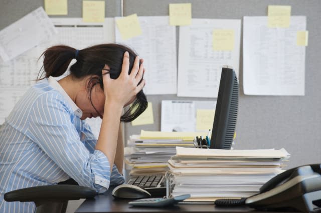 Businesswoman with head in hands