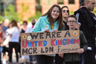 <p>Two music fans display a powerful homemade banner before entering the venue. (SWNS) </p>