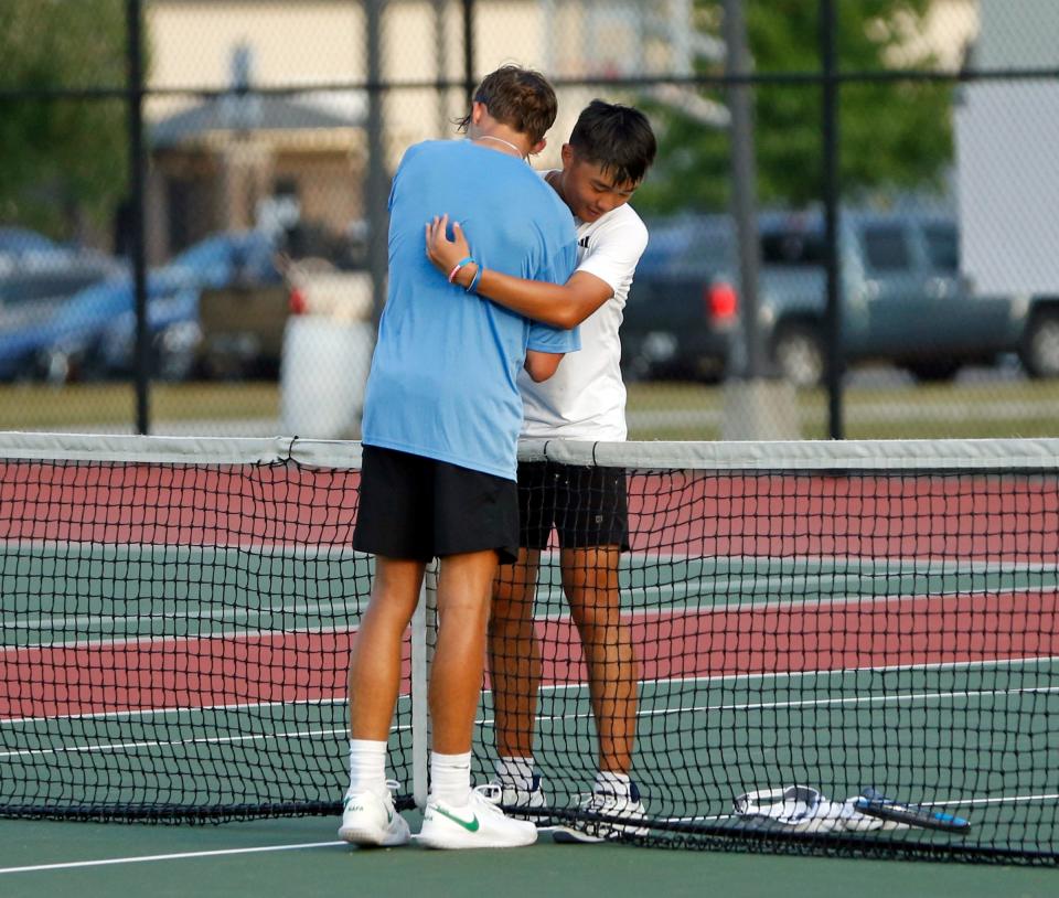 Penn junior Chris Chen, right, and South Bend Saint Joseph senior Colin Blumentritt embrace after their match at No. 1 singles Tuesday, Sept. 5, 2023, at Penn High School in Mishawaka.