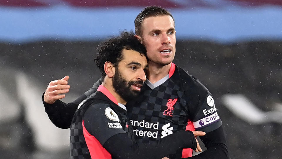 Mo Salah is seen here embracing Liverpool captain Jordan Henderson. 