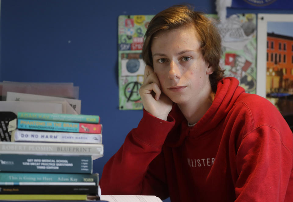 A-Level student and would be medical student Chris Byrne, who is disappointed with his teacher predicted exam results, poses for a photo at home in London, Wednesday, Aug. 19, 2020. Thousands of graduating high school students in Britain are scrambling for university places following the government’s disastrous decision to award final grades using an unfair algorithm to replace exams canceled because of the coronavirus, resulting in mass confusion. “I’m stuck waiting,” Byrne said. “There has been no word about if there’s going to be enough medicine places for me to get in this year."(AP Photo/Kirsty Wigglesworth)