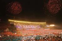 FILE - In this July 1, 1997, file photo, fireworks explode above performers at a show at Beijing's Workers Stadium which marked the return of Hong Kong to Chinese sovereignty. Hong Kong, the former British colony, returns to Chinese rule under the principle of “one country, two systems.” (AP Photo/Katsumi Kasahara, File)