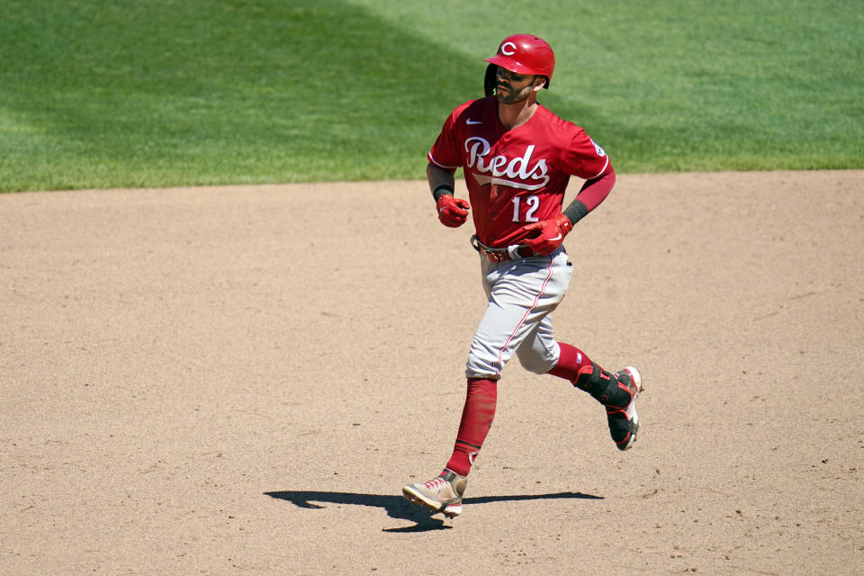 Cincinnati Reds' Tyler Naquin (12) rounds the bases on a three-run home run off Minnesota Twins' relief pitcher Hansel Robles in the ninth inning of a baseball game, Tuesday, June 22, 2021, in Minneapolis. (AP Photo/Jim Mone)