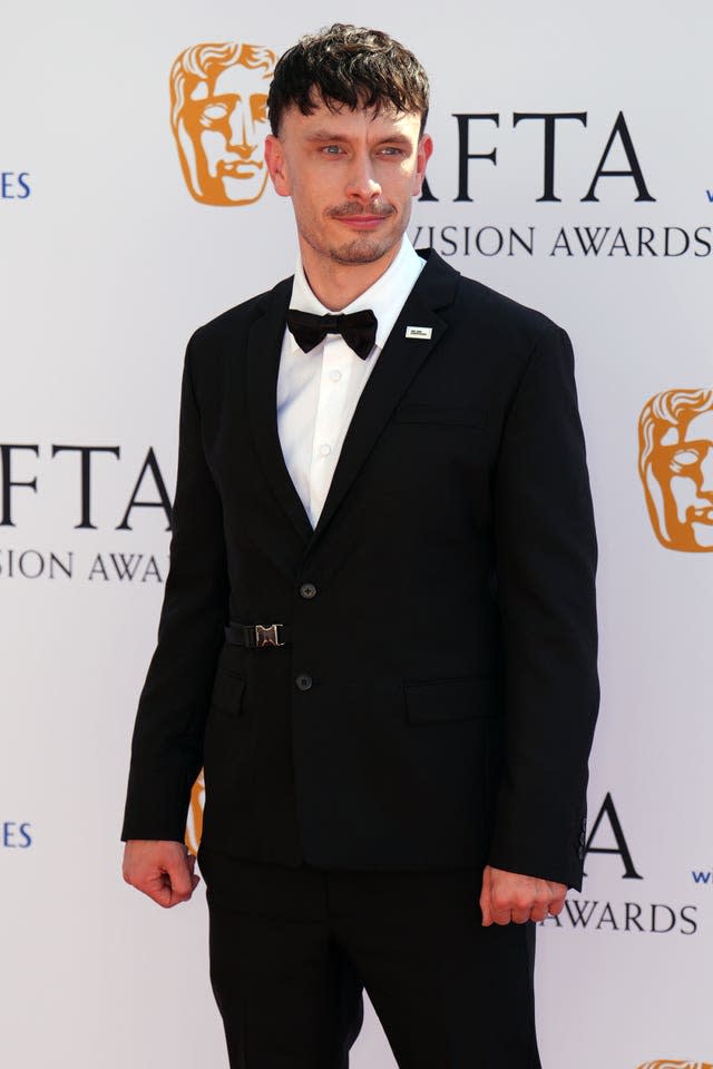 Richard Gadd in black tie in front of Bafta backdrop