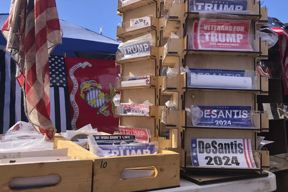 Bumper stickers supporting Florida Gov. Ron DeSantis on sale at former President Donald Trump's rally in Conroe, Texas, Saturday, Jan. 29, 2022. At Trump’s rally, there were signs of change. Next to the Trump hats, shirts and flags sat a collection of Ron “DeSantis 2024” bumper stickers. The vast majority of those interviewed at Trump’s rally enthusiastically cheered the prospect of another Trump run. But there were some who conceded that, perhaps, there might be a better option. (AP Photo/Jill Colvin)