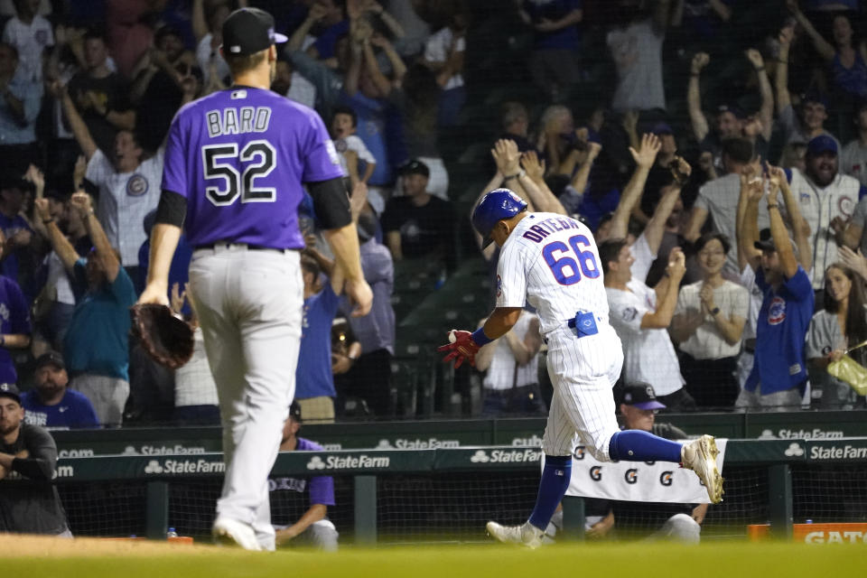 Chicago Cubs' Rafael Ortega celebrates his two-run, walk off home run off Colorado Rockies relief pitcher Daniel Bard, left, during the ninth inning of a baseball game Monday, Aug. 23, 2021, in Chicago. The Cubs won 6-4.(AP Photo/Charles Rex Arbogast)