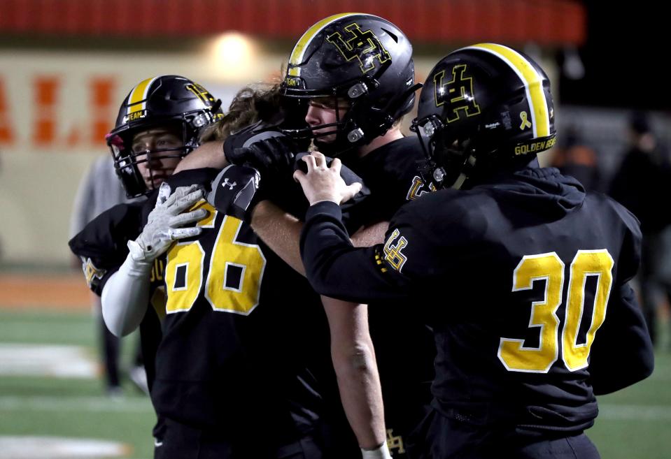 Upper Arlington's Henry Rappolt, center facing, Jake Badgeley (66), Alex Milton (30) and Austin Stutz, left, console each other following a 16-10 loss to Lakewood St. Edward in a Division I state semifinal Nov. 26 at Arlin Field in Mansfield.