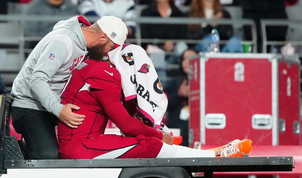 Cardinals quarterback Kyler Murray (1) goes down injured during the first half of a game against the Patriots at State Farm Stadium in Glendale on Dec. 12, 2022.