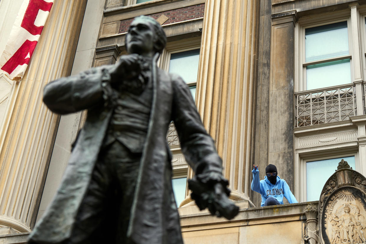 A masked pro-Palestinian protester at Hamilton Hall, an occupied building at Columbia University in upper Manhattan, on Tuesday, April 30, 2024.  (Bing Guan/The New York Times)