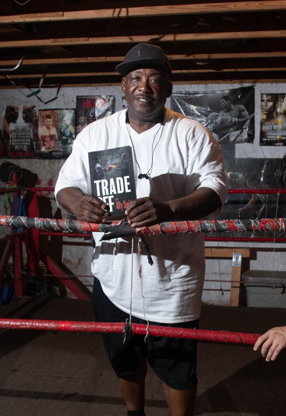 Boxing trainer Alfy Smith holds his book in Pensacola on Wednesday, Sept. 27, 2023.