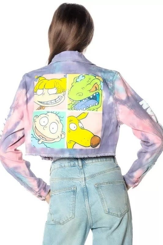 Model facing away wearing tie-dyed denim jacket with Rugrats characters Tommy, Chuckie, Angelica, and Reptar