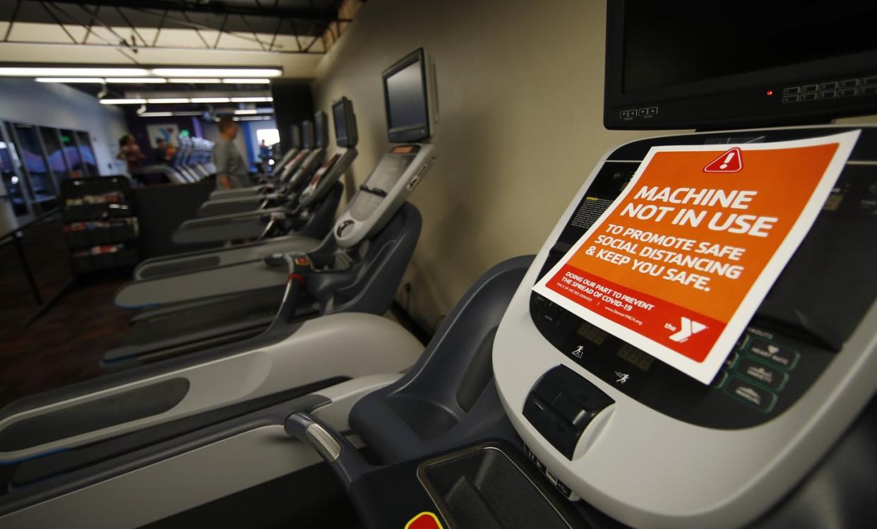 <span class="caption">Signs cover the control panel of exercise machines in a Denver YMCA, March 15, 2020. </span> <span class="attribution"><a class="link " href="http://www.apimages.com/metadata/Index/Virus-Outbreak-Colorado/f7664a6dc8994df39a81a3a8a9437463/3/0" rel="nofollow noopener" target="_blank" data-ylk="slk:AP Photo/David Zalubowski;elm:context_link;itc:0;sec:content-canvas">AP Photo/David Zalubowski</a></span>