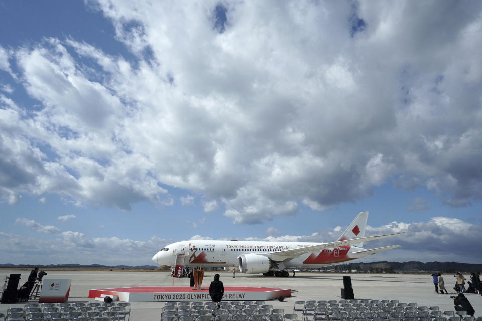 A plane carrying the Olympic flame arrives before Olympic Flame Arrival Ceremony at Japan Air Self-Defense Force Matsushima Base in Higashimatsushima in Miyagi Prefecture, north of Tokyo, Friday, March 20, 2020. The Olympic flame from Greece is set to arrive in Japan even as the opening of the the Tokyo Games in four months is in doubt with more voices suggesting the games should to be postponed or canceled because of the worldwide virus pandemic. (AP Photo/Eugene Hoshiko)