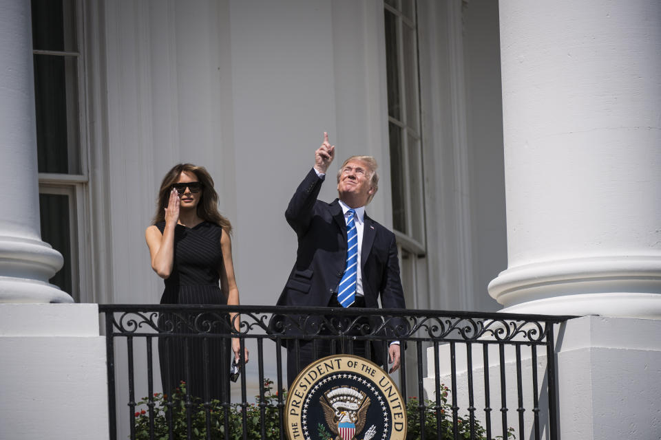 President Trump looks up toward the solar eclipse without glasses.