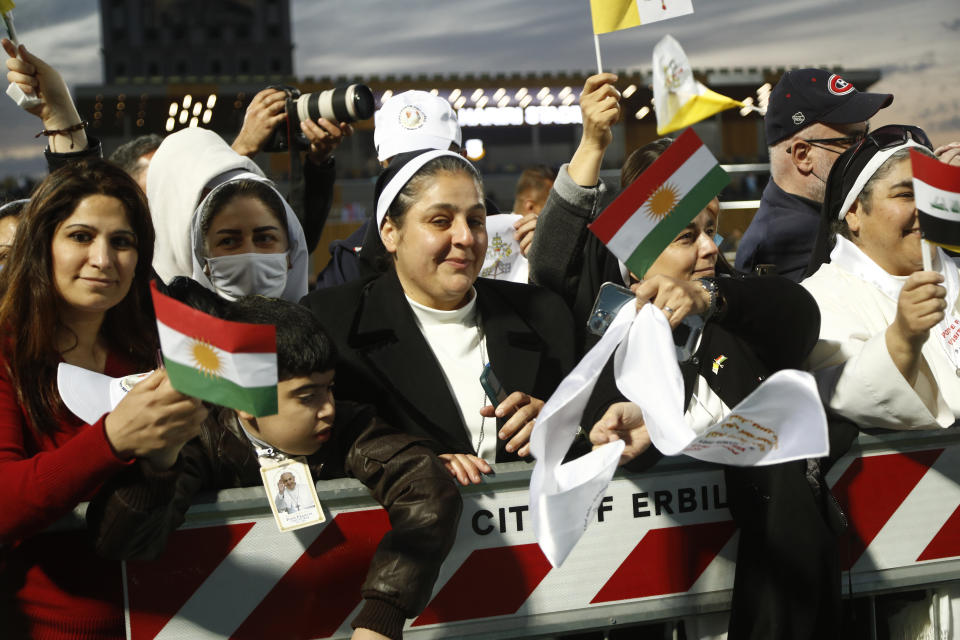 Iraqi Christians say goodbye to Pope Francis after an open air Mass at a stadium in Irbil, Iraq, Sunday, March 7, 2021. (AP Photo/Hadi Mizban)