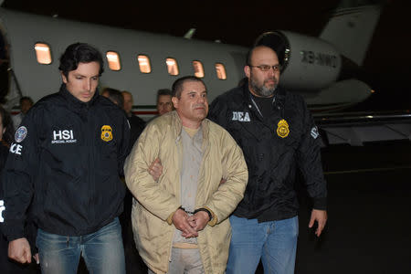 Mexico's top drug lord Joaquin "El Chapo" Guzman is escorted as he arrives at Long Island MacArthur airport in New York, U.S., January 19, 2017, after his extradition from Mexico. U.S. officials/Handout via REUTERS