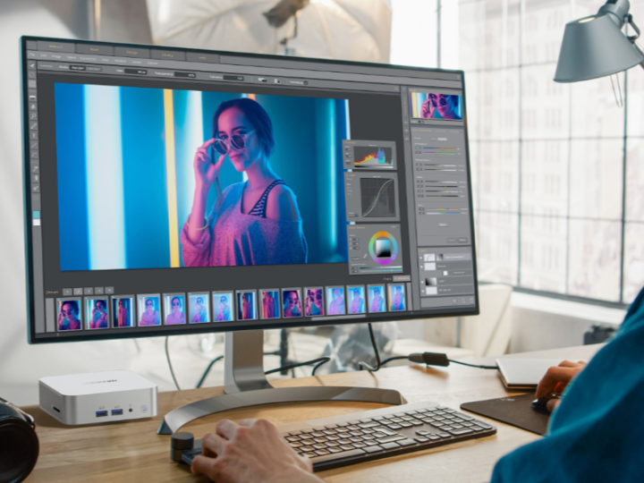 Man using Geekom A7 Mini PC at desk for remote work and design.