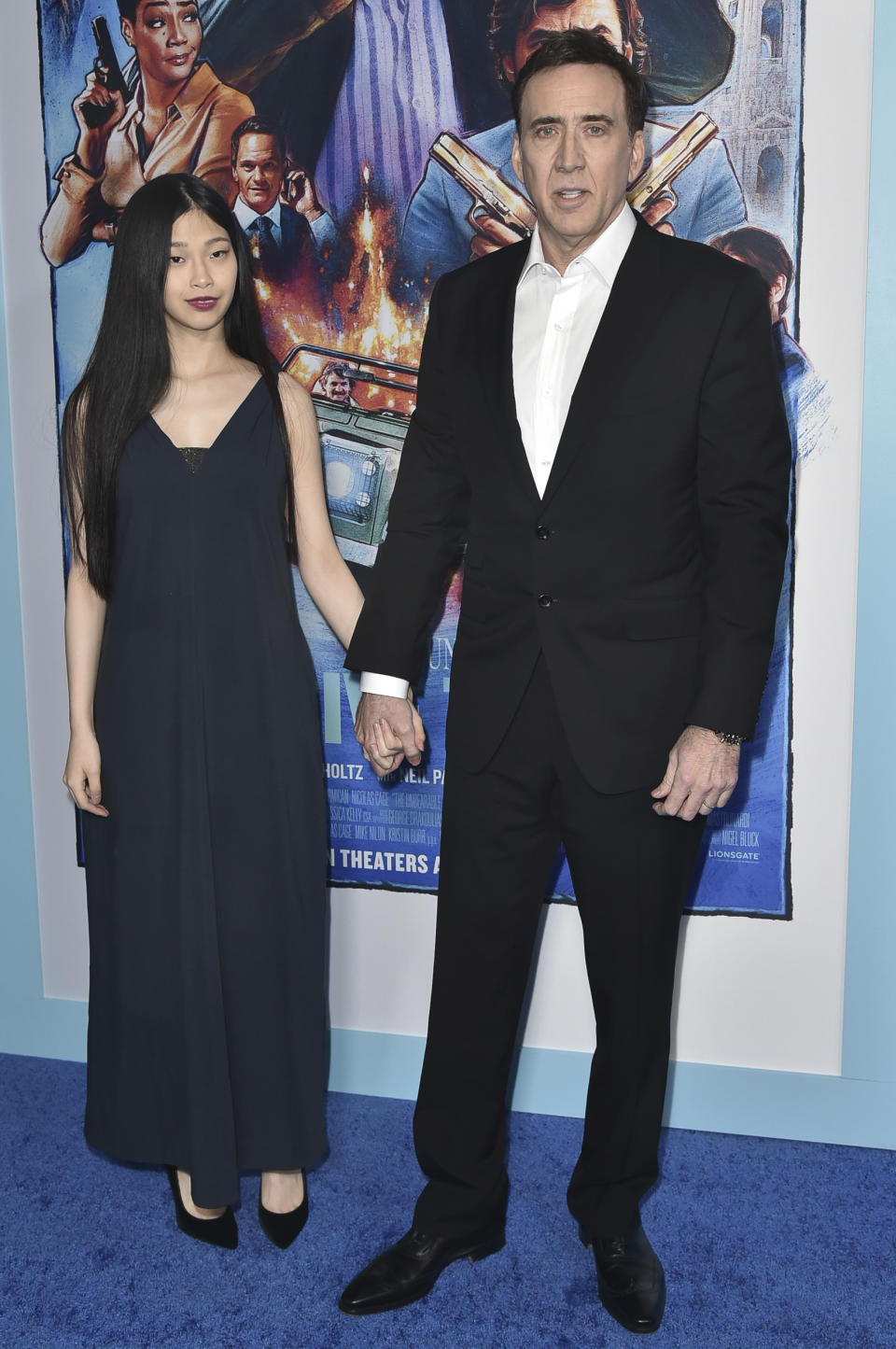 Nicolas Cage, derecha, y Riko Shibata llegan al estreno de "The Unbearable Weight of Massive Talent" (“El peso del talento”) en el Sindicato de Directores de Estados Unidos el 18 de abril de 2022 en Los Angeles. (Foto Richard Shotwell/Invision/AP)