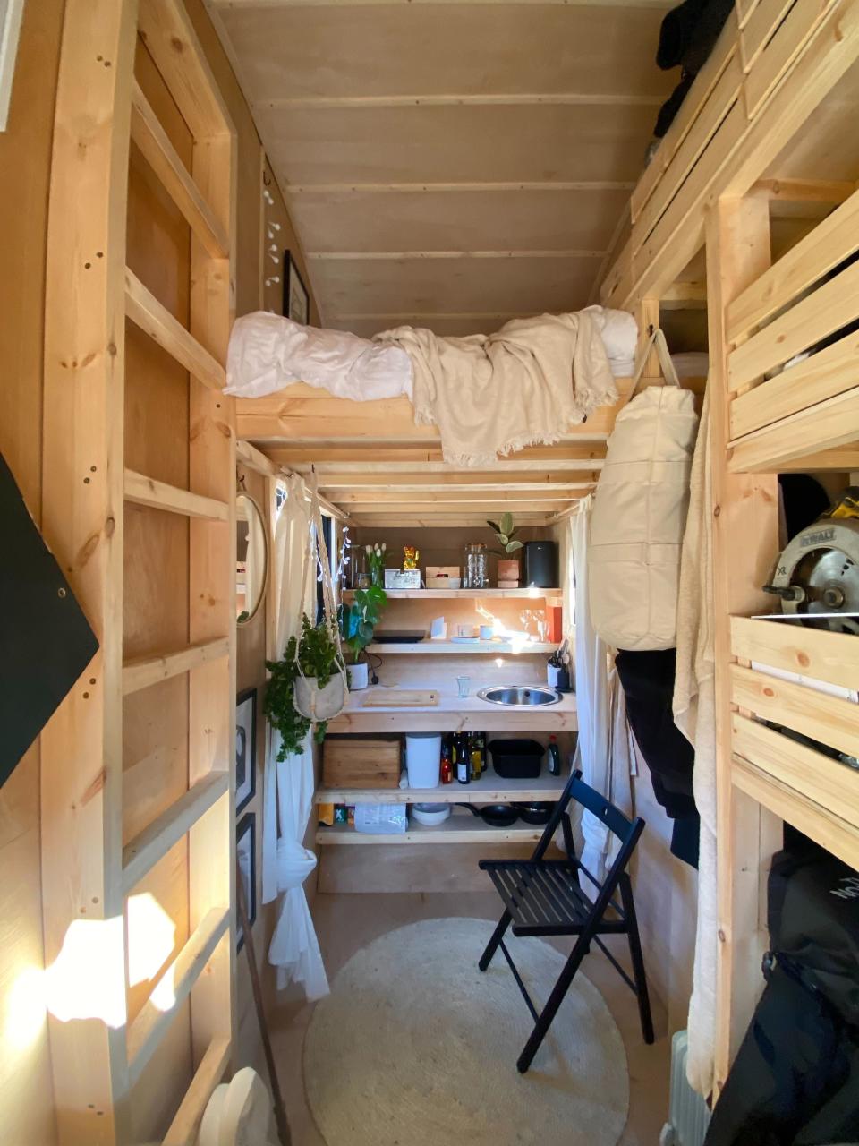 There's a mezzanine bed and storage space on either side of the tiny home