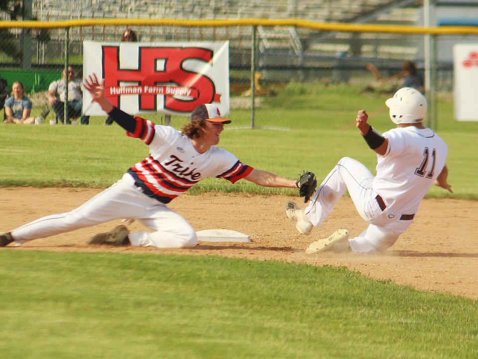 Pontiac shortstop Johnny Lenox lunges to tag out Tremont's Alex Garcia, who was attempting to steal second, Monday.